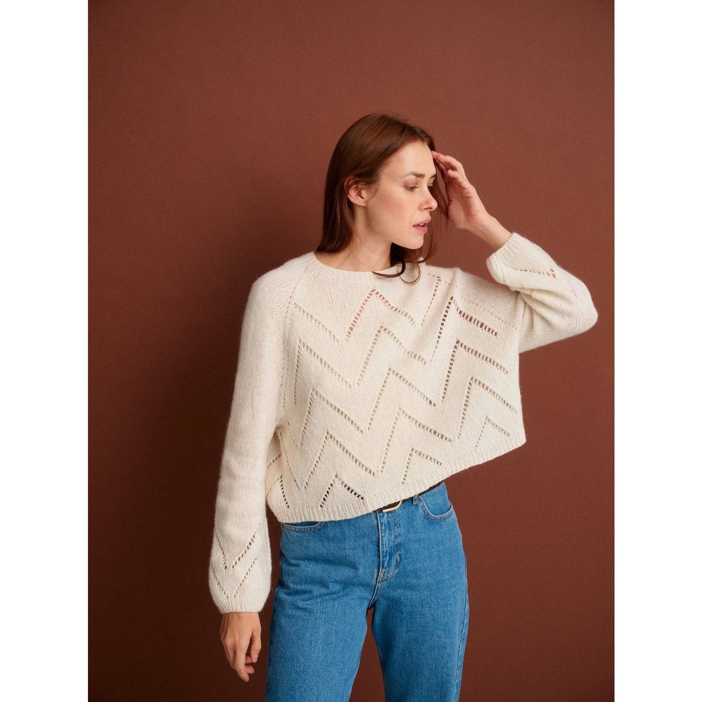 Comfortable cream sweater featuring zigzag designs, showcasing patterns in knitting for stylish outfits.