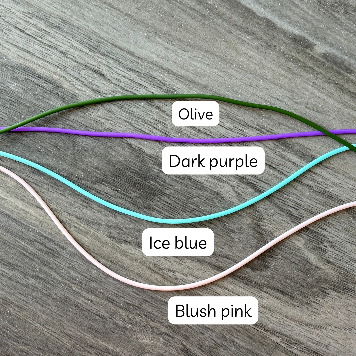 Colorful knitting tools including olive, dark purple, ice blue, and blush pink yarn cords