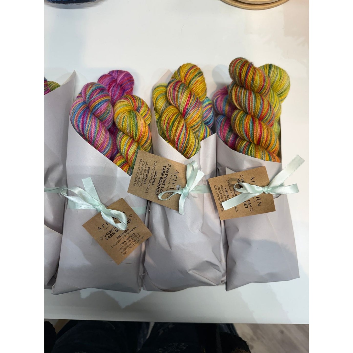 Colorful Koigu yarn bouquet Valentine’s gift wrapped in elegant paper at AriYARN Shop