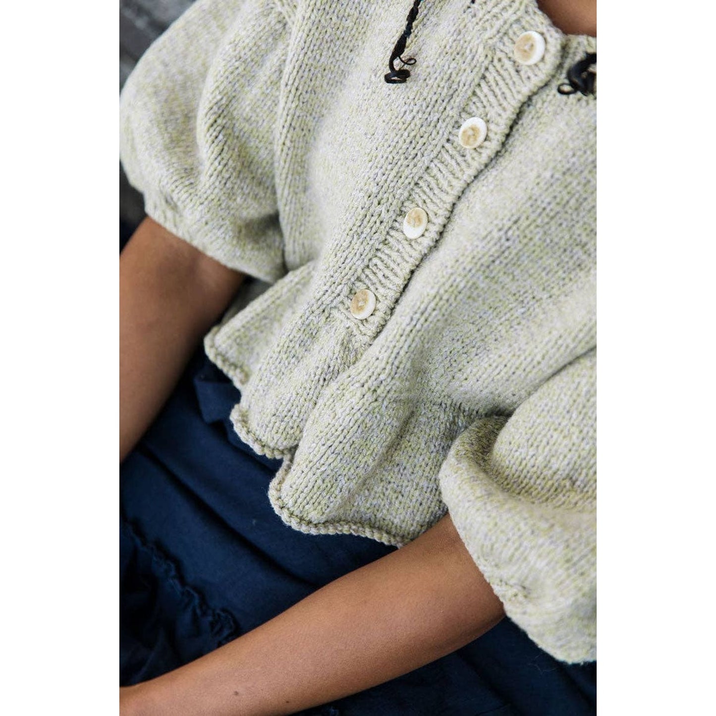 Laine Magazine Issue 25 showcasing a cozy knitted top with oversized sleeves and button details