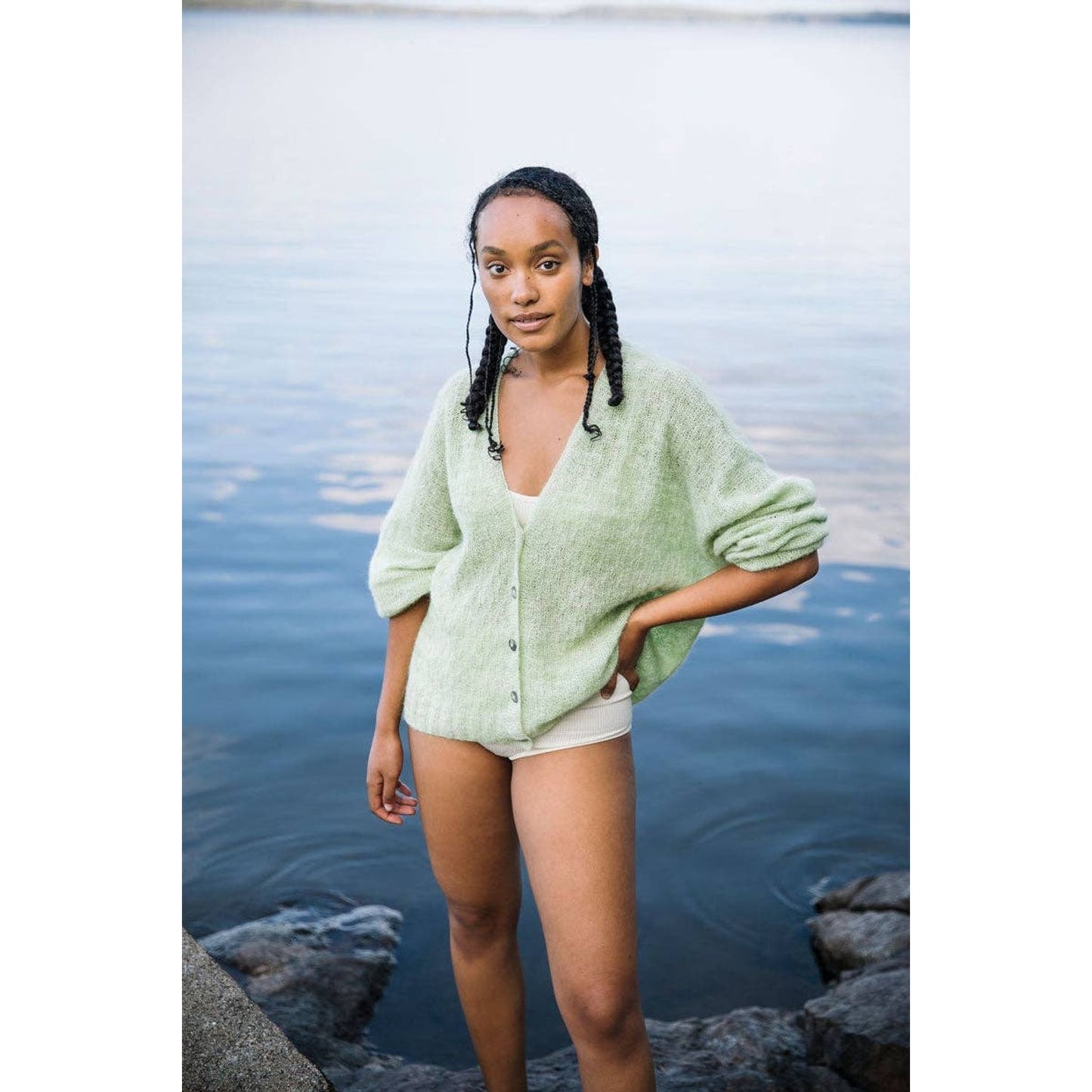 Model wearing a light green cardigan from Laine Magazine Issue 25 by Laine Publishing by the water