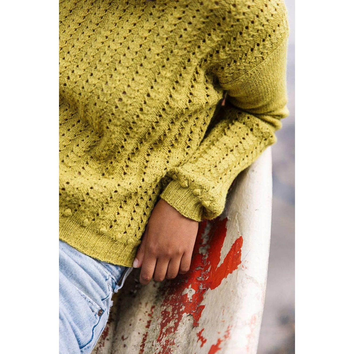 Laine Magazine Issue 25 showcasing a model wearing a textured green knitted sweater