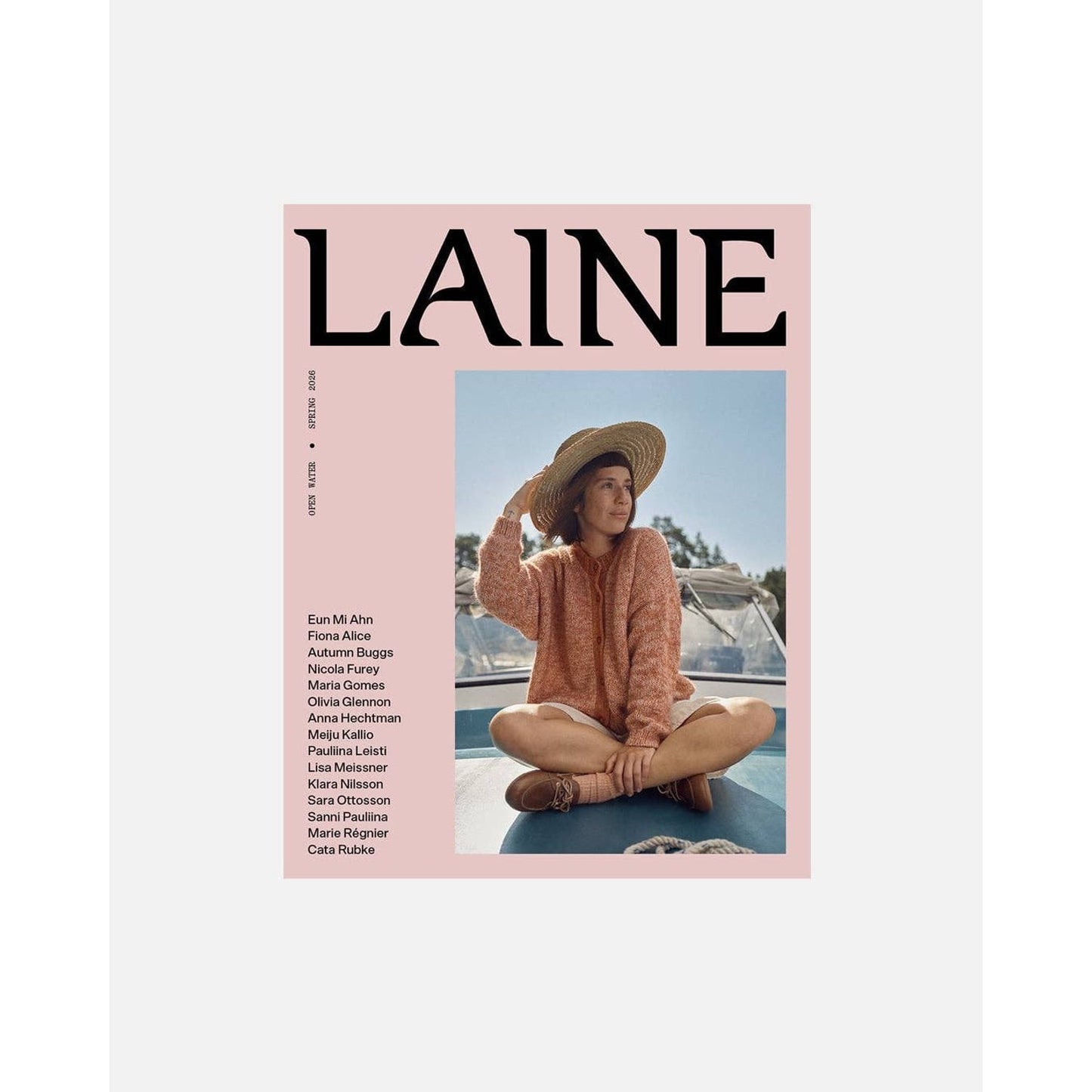 Laine Magazine Cover Featuring Stylish Woman in Sweater and Sun Hat on a Boat