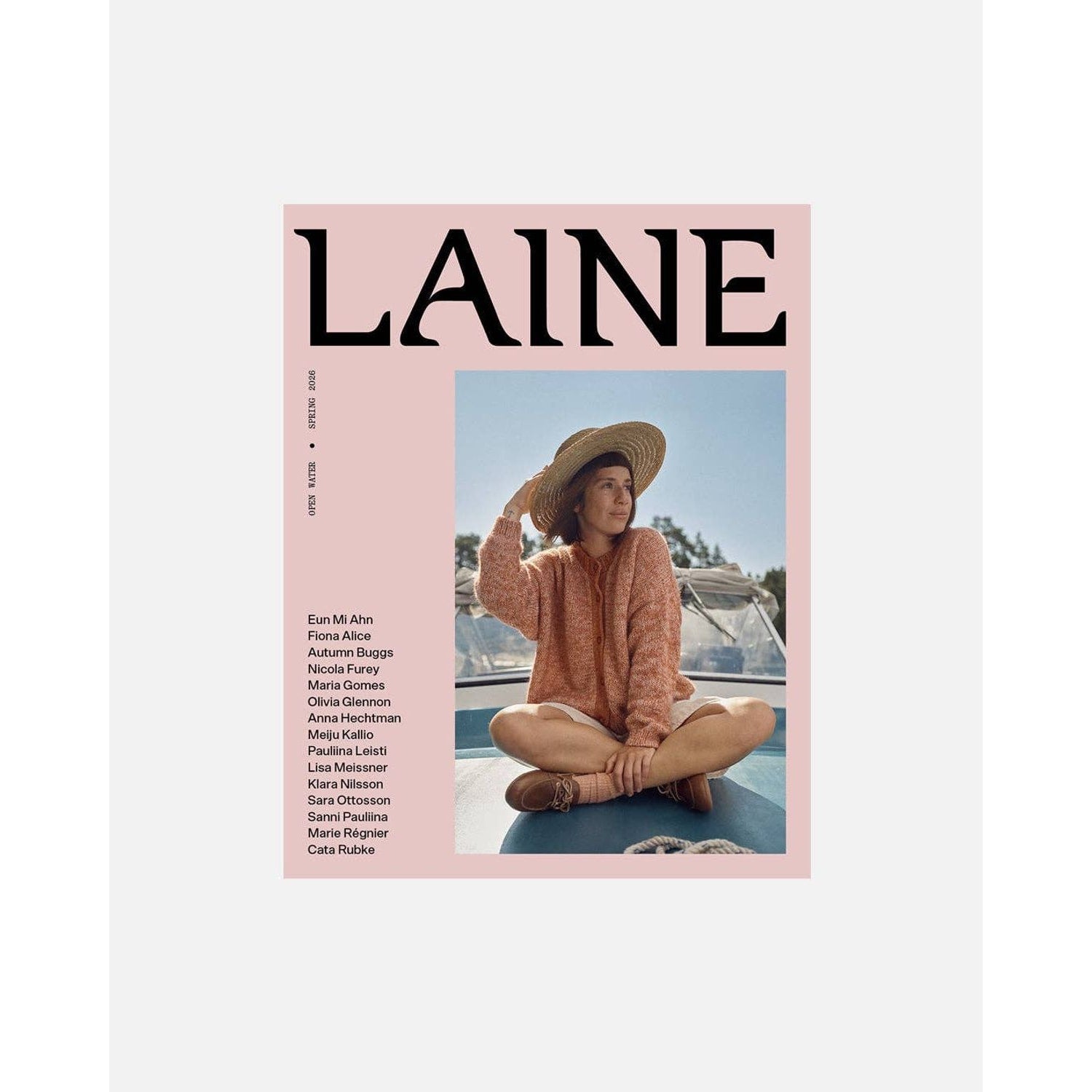 Laine Magazine Cover Featuring Stylish Woman in Sweater and Sun Hat on a Boat