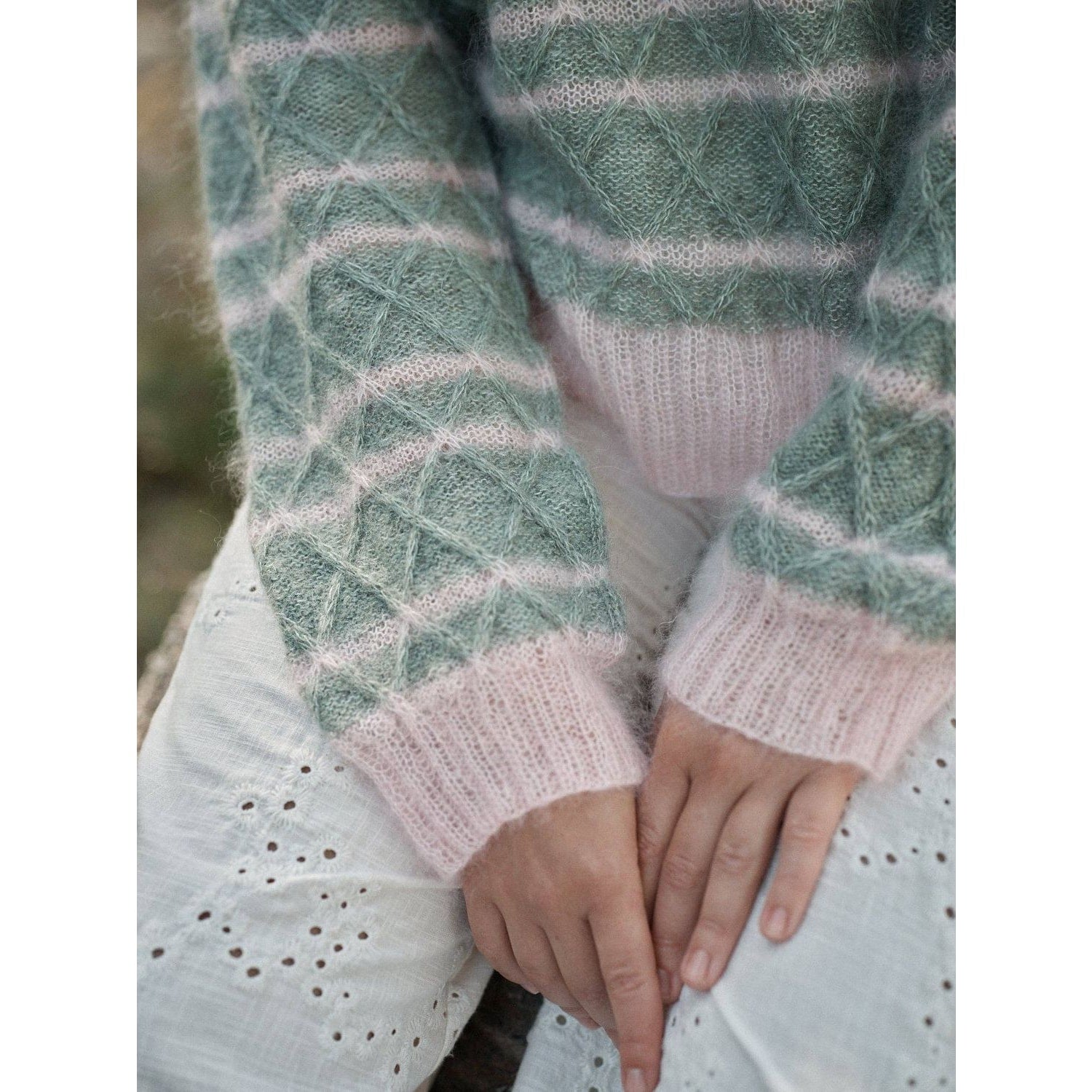 Cozy pastel striped sweater from Laine Magazine showcasing intricate diamond patterns for stylish comfort