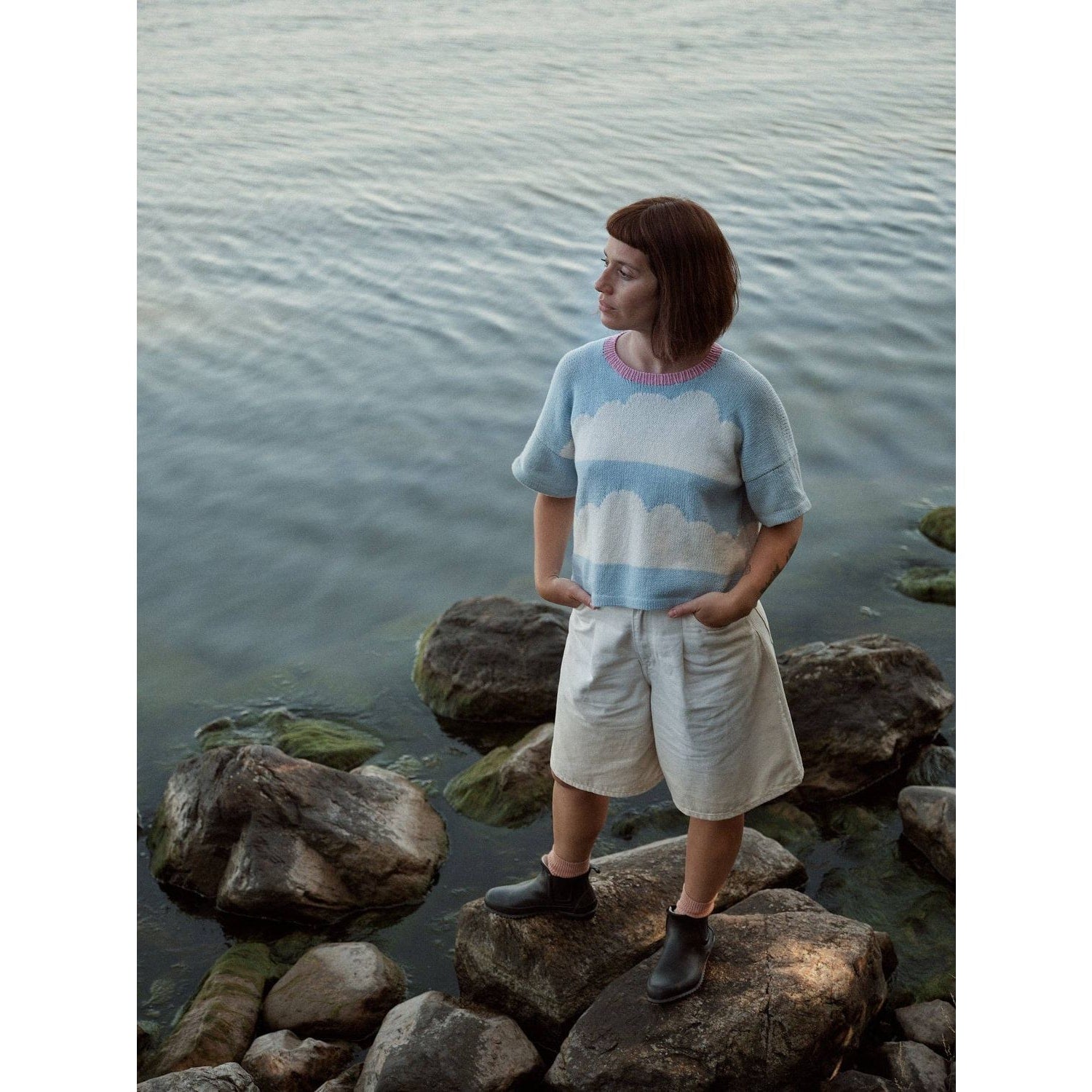 Woman wearing a blue and white striped sweater and shorts, featured in laine magazine