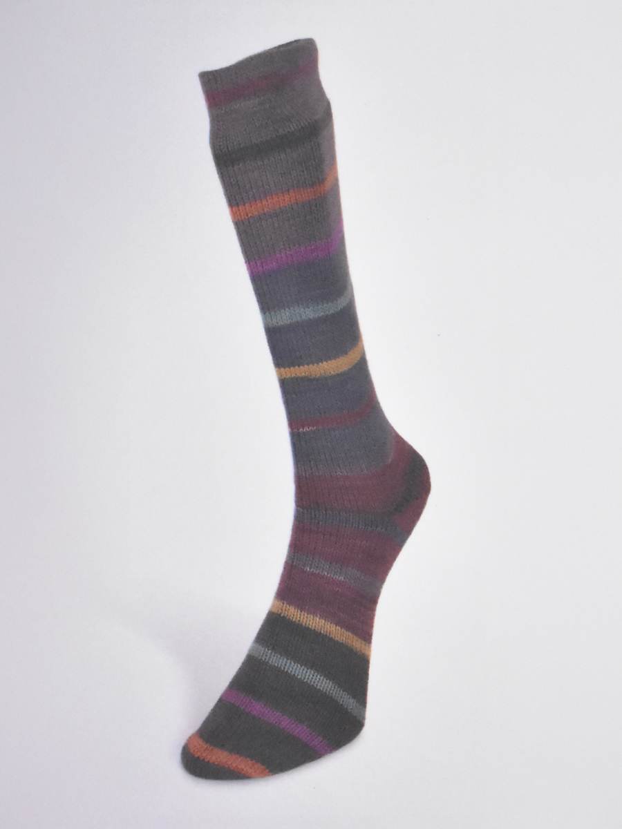 Laines du Nord Indulgence sock yarn knitted sock in shades of gray, purple, and orange stripes