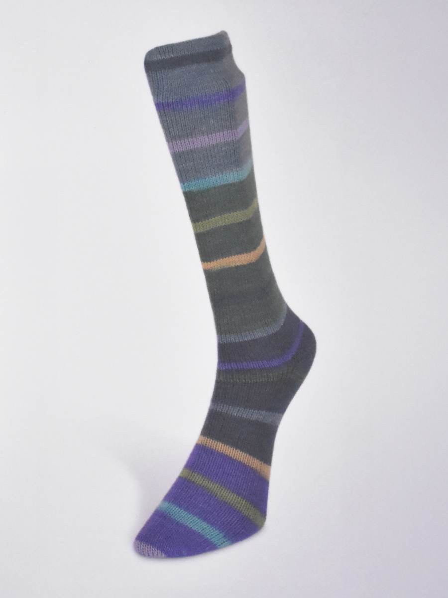 Hand-knit sock made from Laines du Nord Indulgence sock yarn in shades of gray and colorful stripes