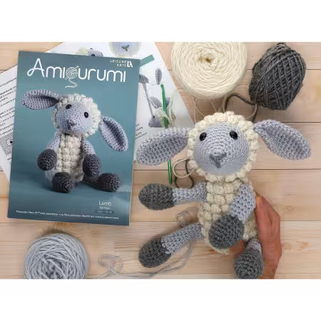 Leisure Arts amigurumi kit lamb with crochet yarn and instructional booklet for crafting enthusiasts
