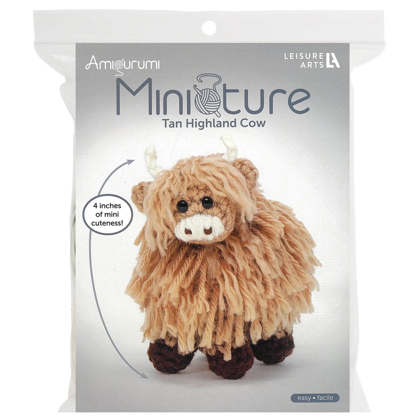 Leisure Arts miniature crochet cow kit featuring a tan highland cow with fluffy texture and cute design