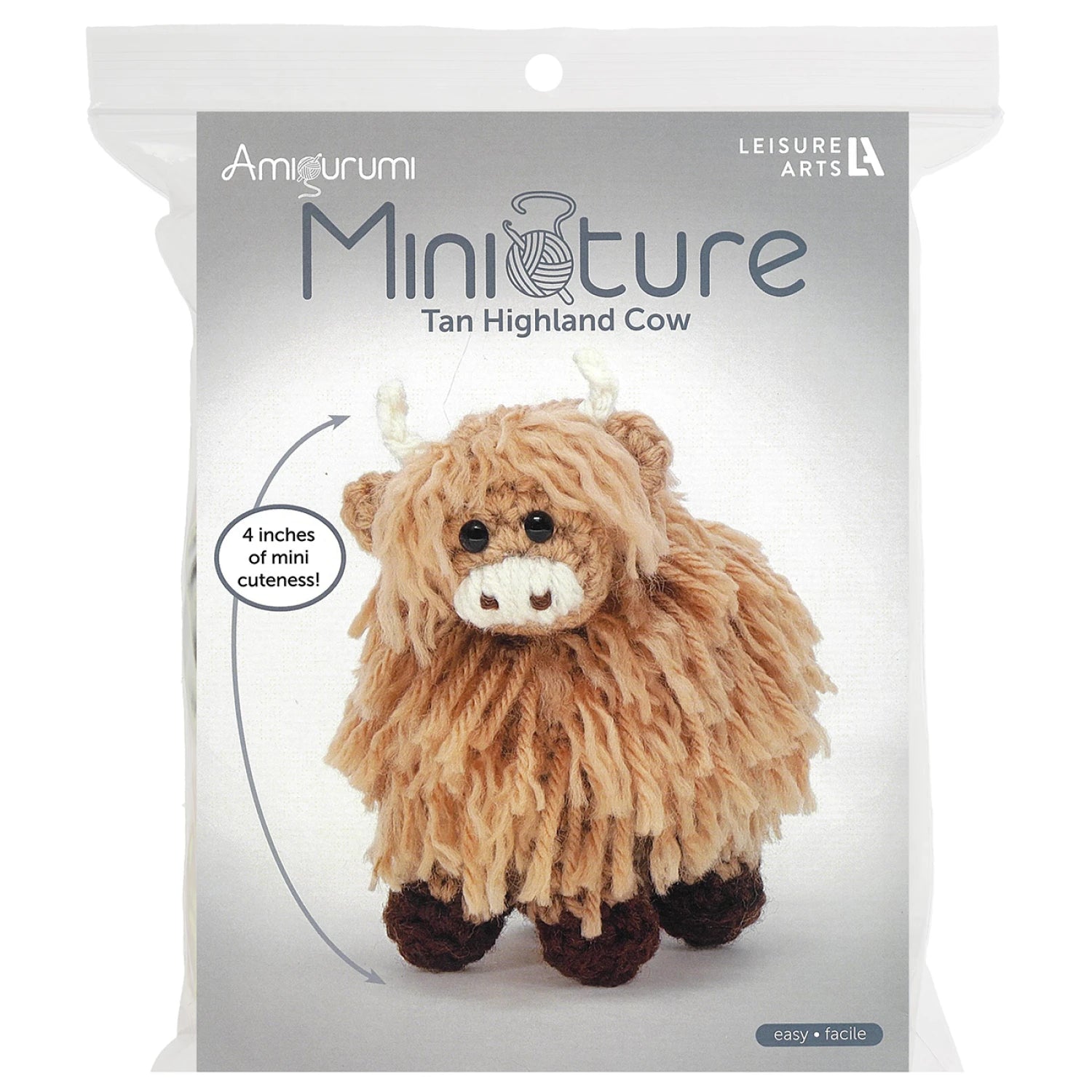 Leisure Arts miniature crochet cow kit featuring a tan highland cow with fluffy texture and cute design