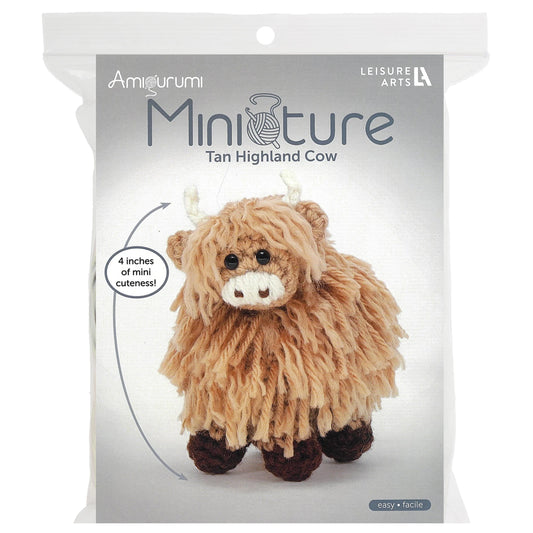 Leisure Arts miniature crochet cow kit featuring a tan highland cow with fluffy texture and cute design