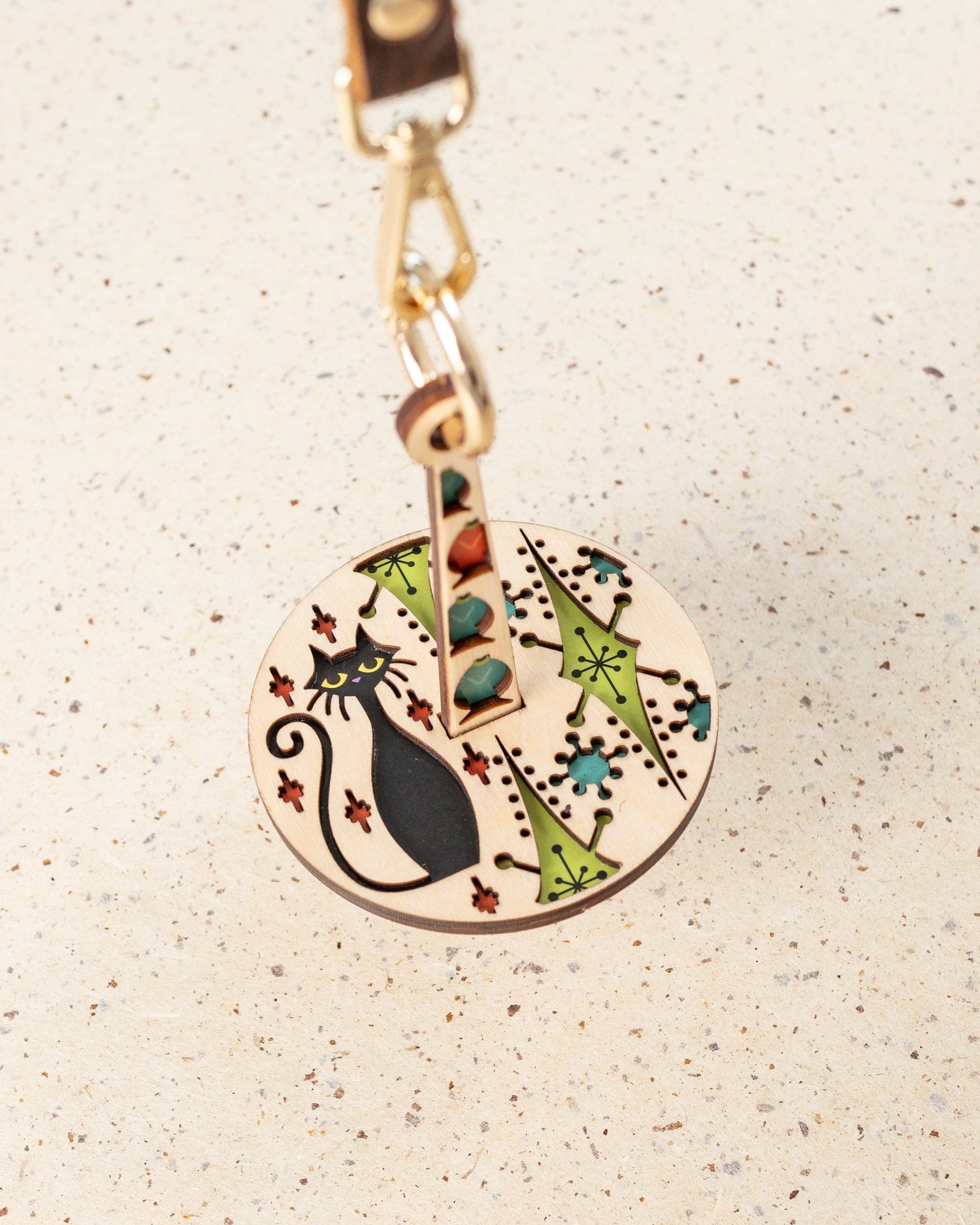 lemonwood kitty kitty yarn accessory round wooden cat keychain with black cat silhouette and retro floral inlay