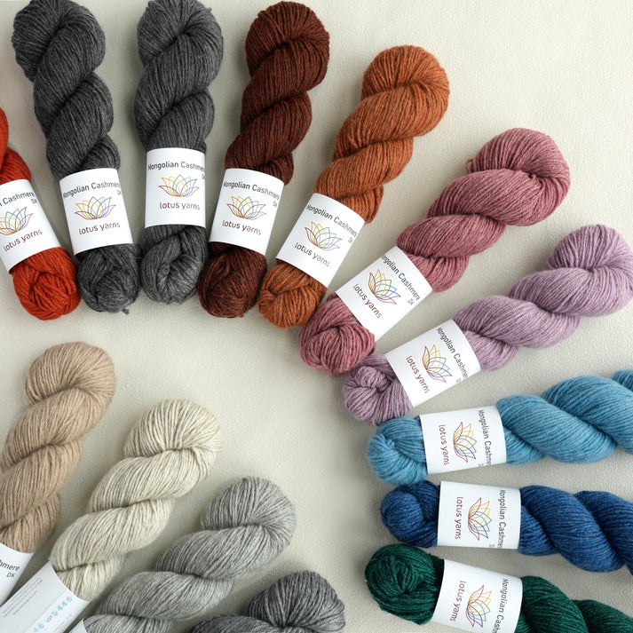 Assorted DK yarn skeins from Lotus Yarns in various colors for knitting and crocheting projects