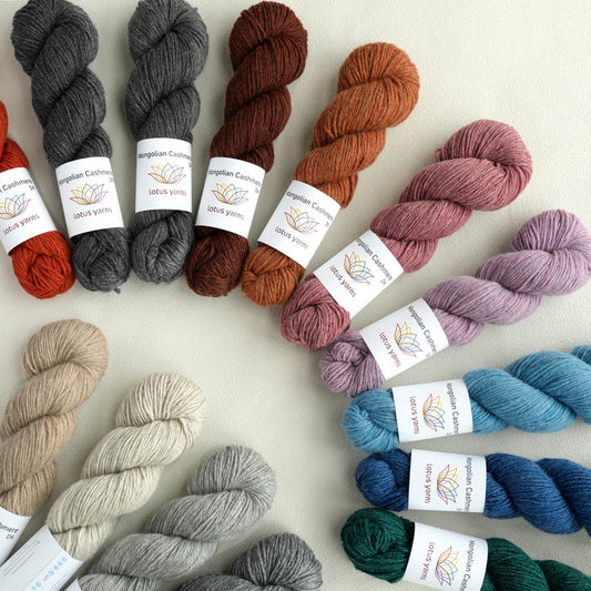 Assorted DK yarn skeins from Lotus Yarns in various colors for knitting and crocheting projects