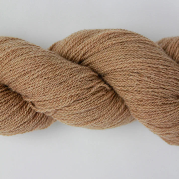 Soft beige lotus yarns for knitting and crocheting, perfect for cozy projects