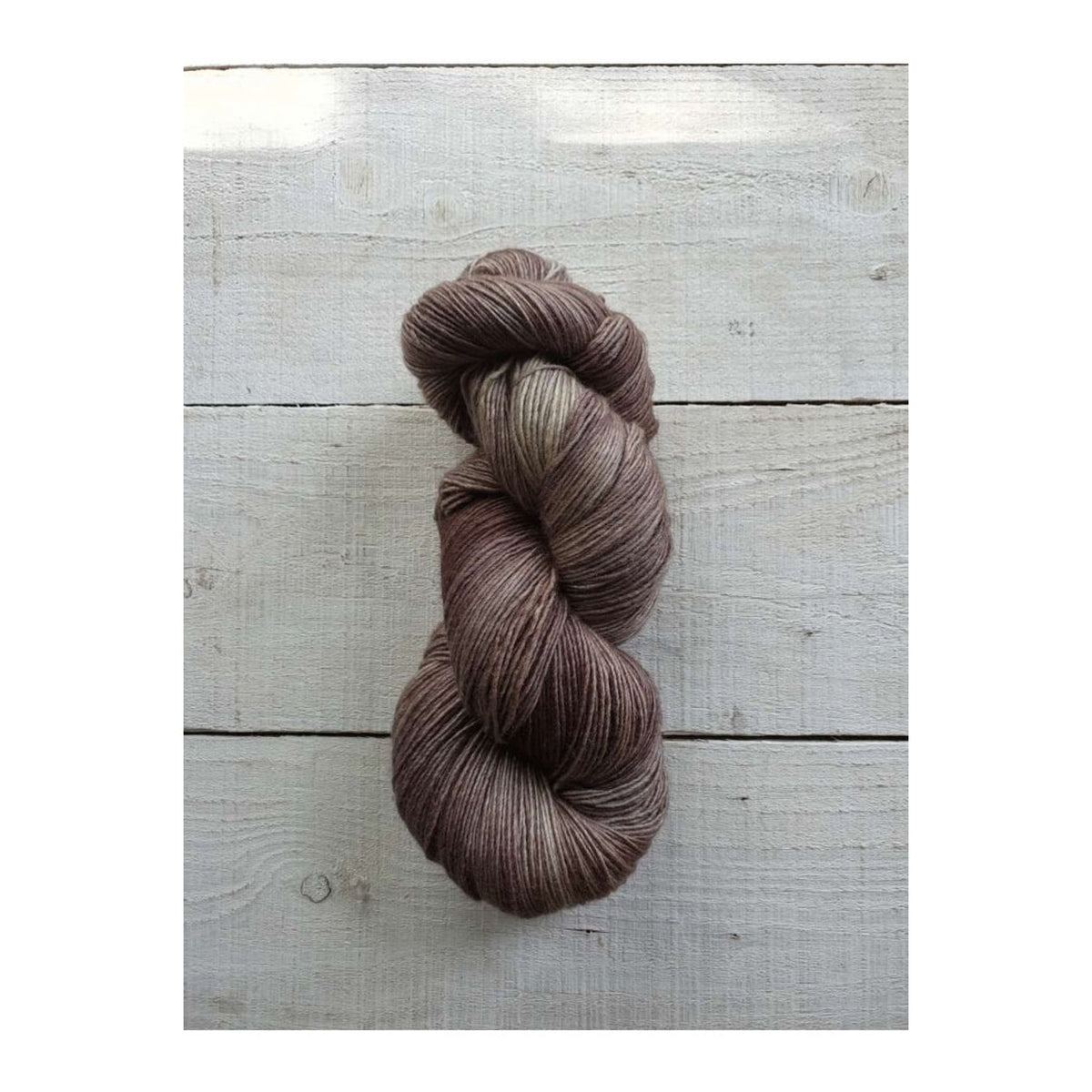 Manos del Uruguay Fino yarn in rich brown tones, perfect for knitting and crocheting projects