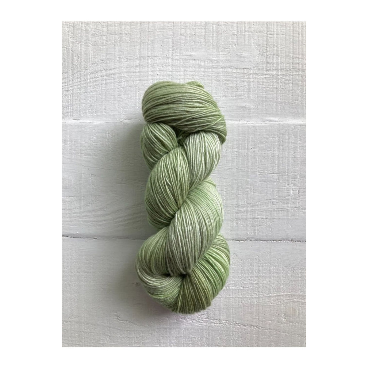 Manos del Uruguay Fino yarn in soft green shades, perfect for delicate knitting projects