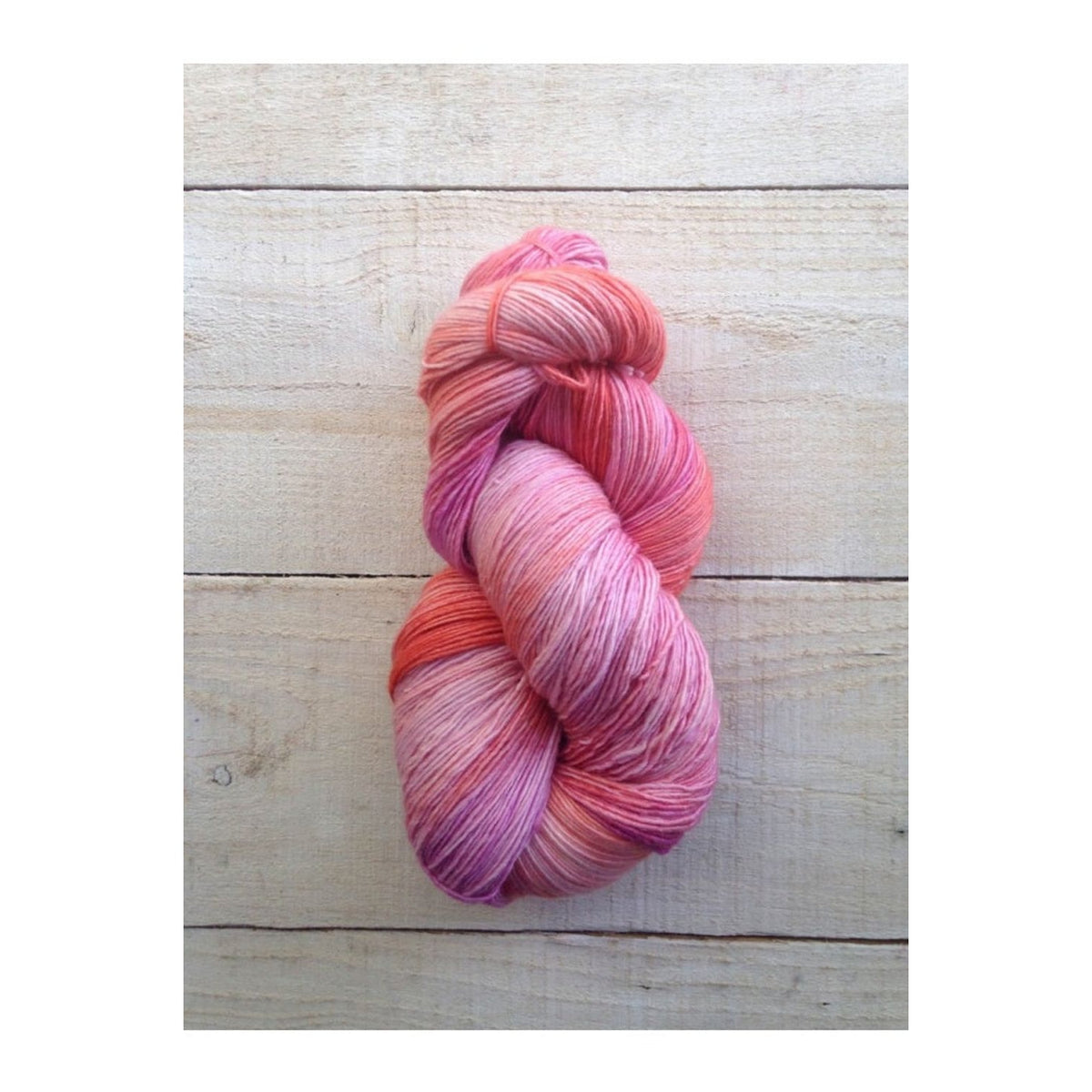 Manos del Uruguay Fino yarn in pink and coral hues, perfect for delicate knitting projects