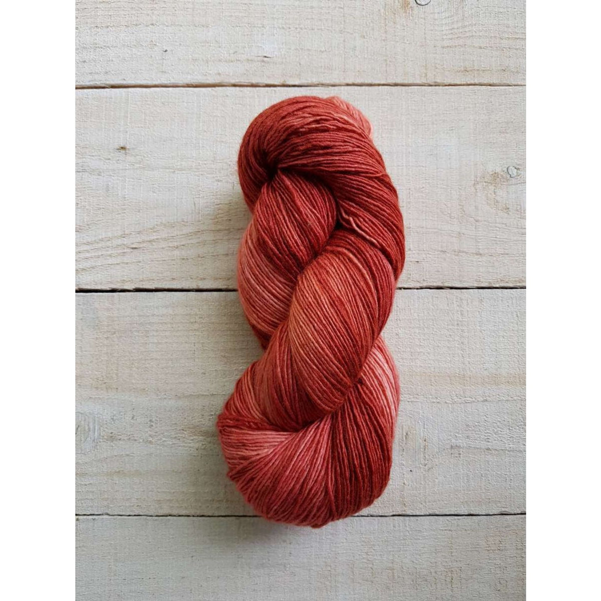 Manos del Uruguay Fino yarn in warm shades of red, perfect for knitting and crocheting projects