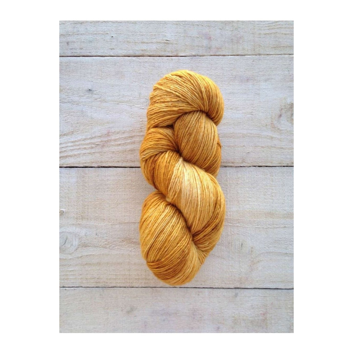 Manos del Uruguay Fino yarn in golden yellow color, perfect for knitting and crocheting projects