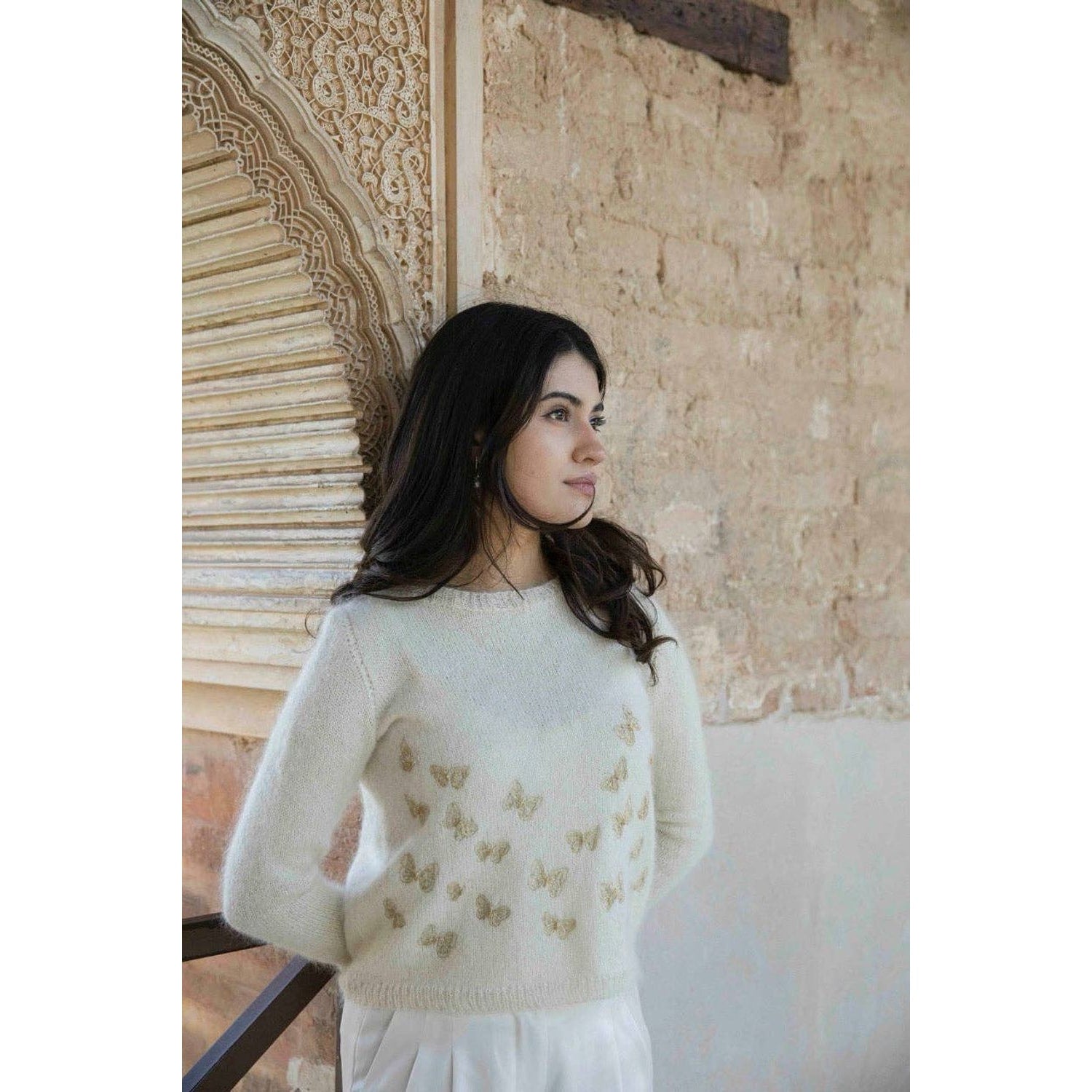 Memory Lane knitting book displayed with a model wearing a cozy sweater featuring butterfly motifs