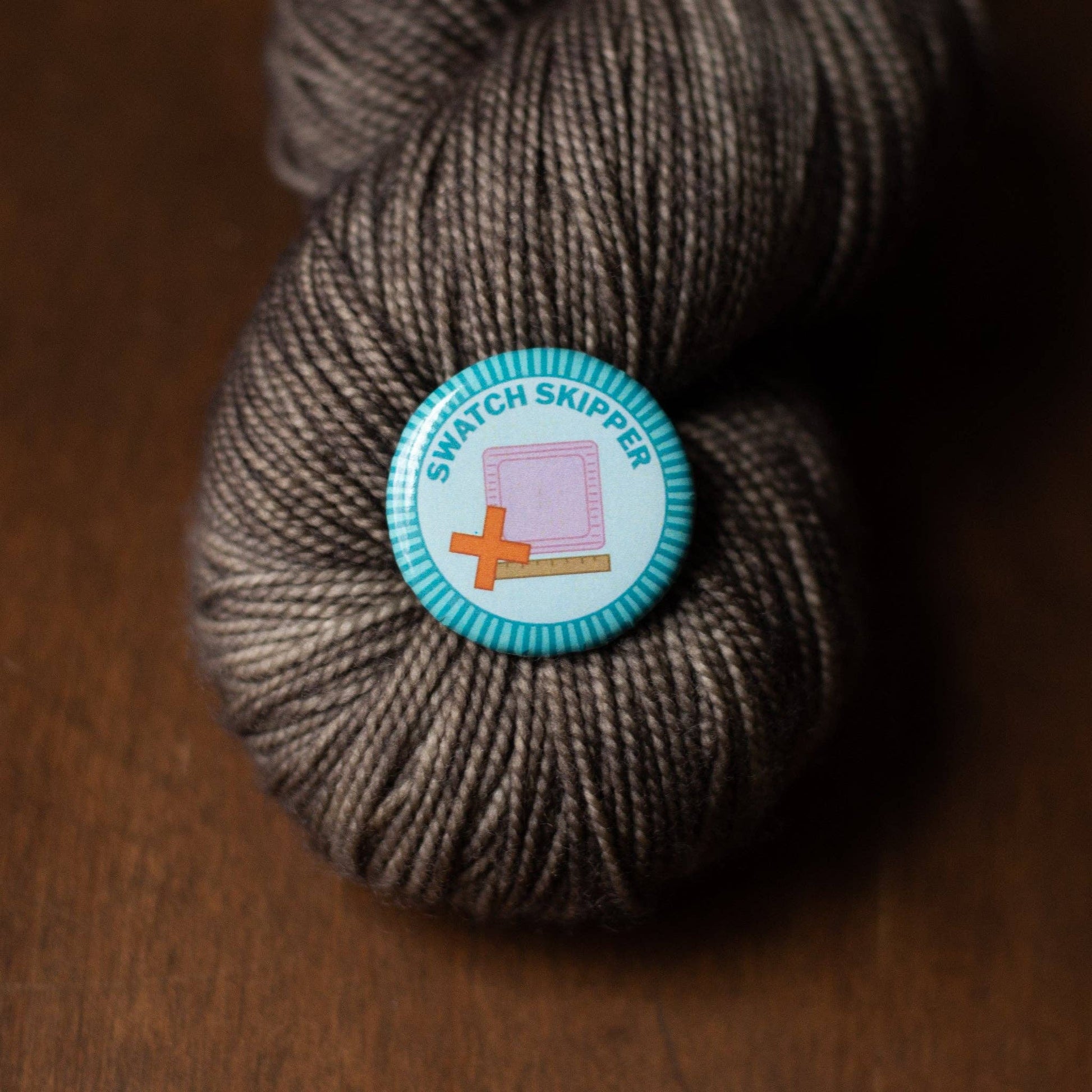 Soft gray yarn skein with Swatch Skipper badge, essential for merit badge required for eagle projects.