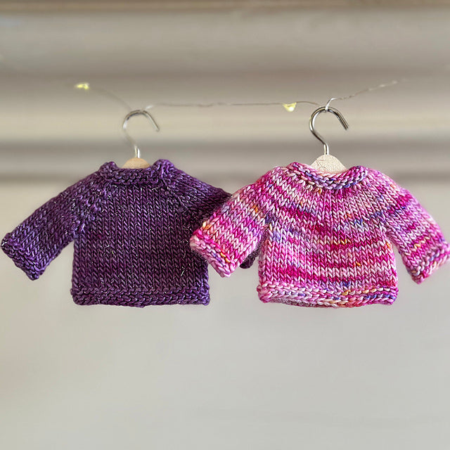 Hand-knitted purple and pink sweaters for miniature dachshund from AriYARN Shop and Studio