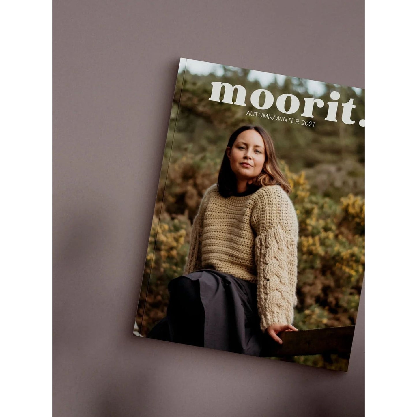 Moorit Magazine crochet patterns cover featuring woman in chunky cable knit sweater outdoors autumn scene