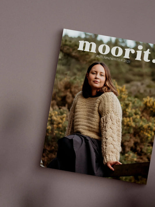 Moorit Magazine crochet patterns cover featuring woman in chunky cable knit sweater outdoors autumn scene