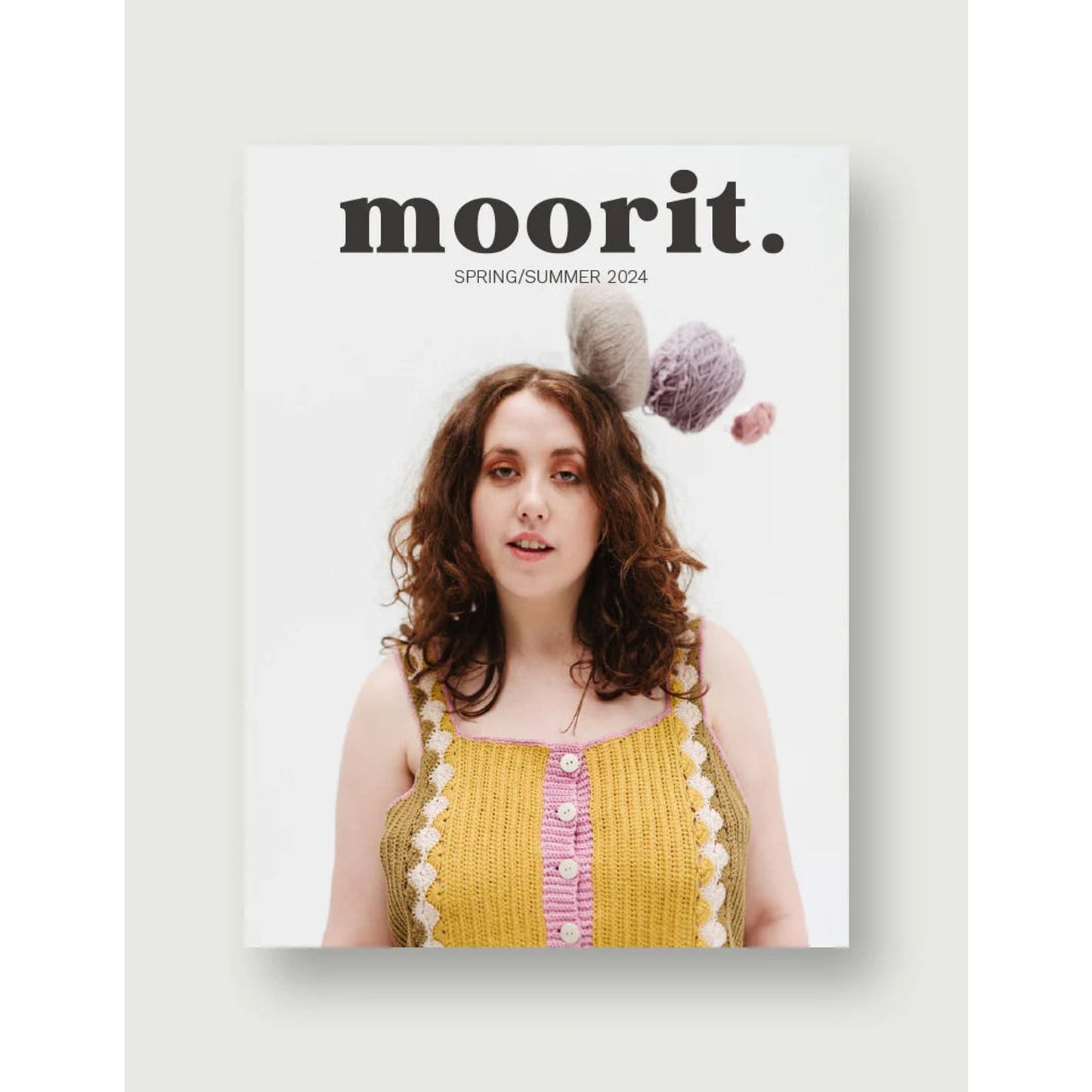 Moorit Magazine crochet patterns cover showing model in yellow crocheted tank top with yarn balls overhead