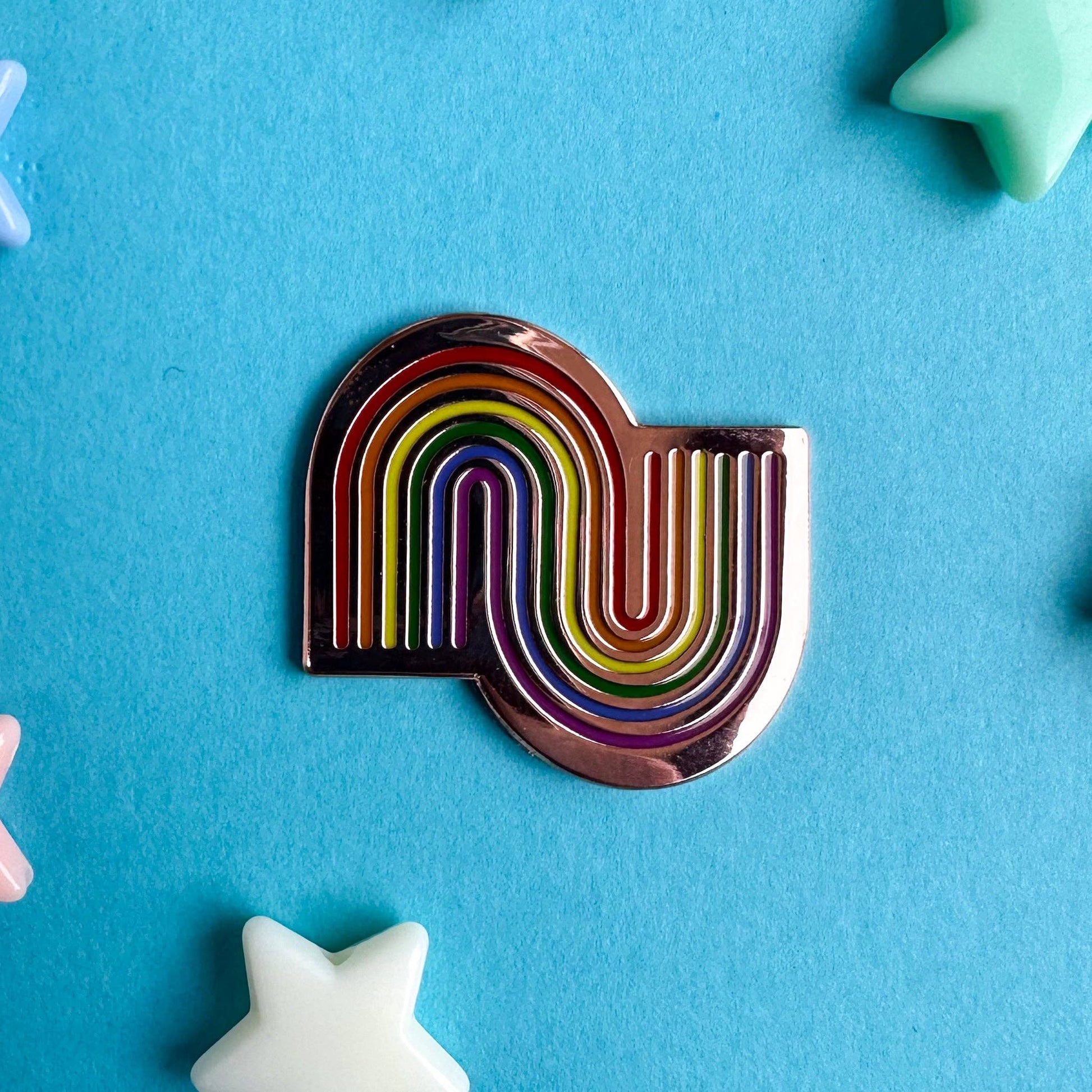 Colorful Kitty With A Cupcake needle minder shaped like a rainbow for easy needle holding