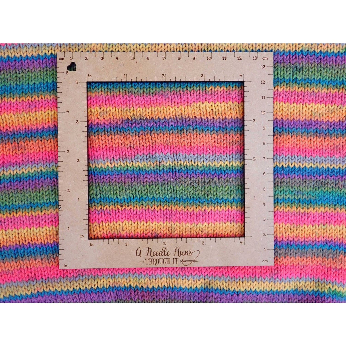 Colorful knitted fabric with a gauge swatch tool by A Needle Runs Through It for knitting a gauge swatch