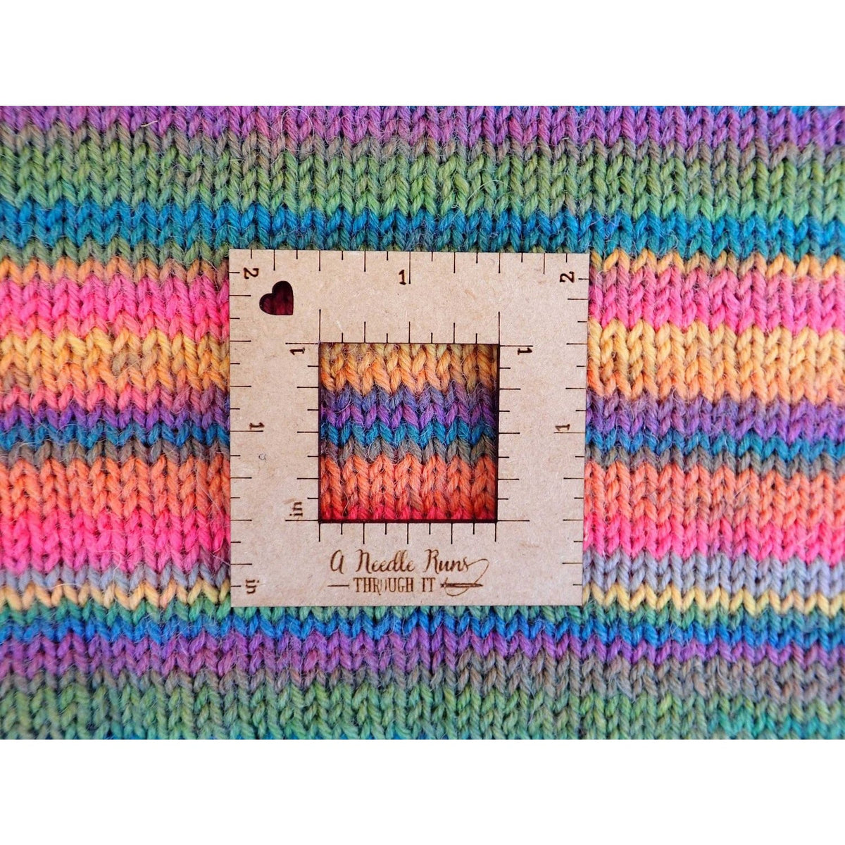 Colorful knitted fabric showing gauge swatch measurements for knitting a gauge swatch