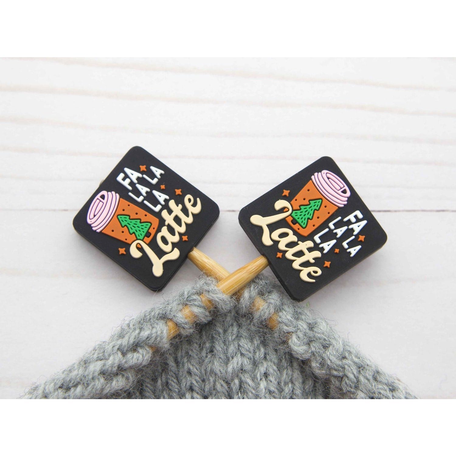 Fa La La La Latte stitch stopper set. Black square stitch stoppers with latte cup design on knitting needles