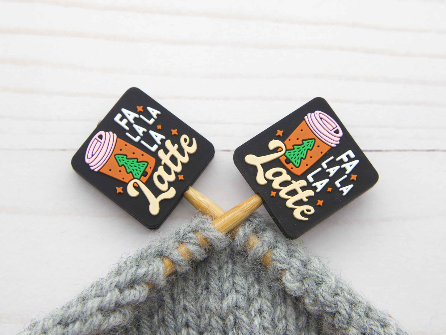 Fa La La La Latte stitch stopper set. Black square stitch stoppers with latte cup design on knitting needles