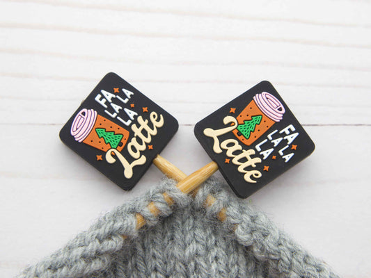 Fa La La La Latte stitch stopper set. Black square stitch stoppers with latte cup design on knitting needles