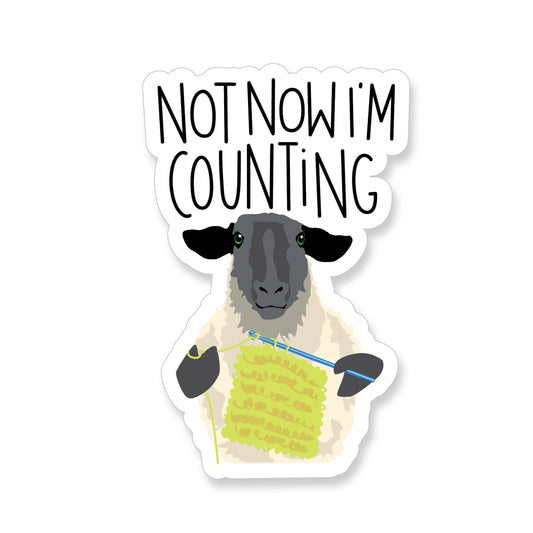 Not now I'm counting crochet sticker featuring a sheep knitting with black ears and green eyes