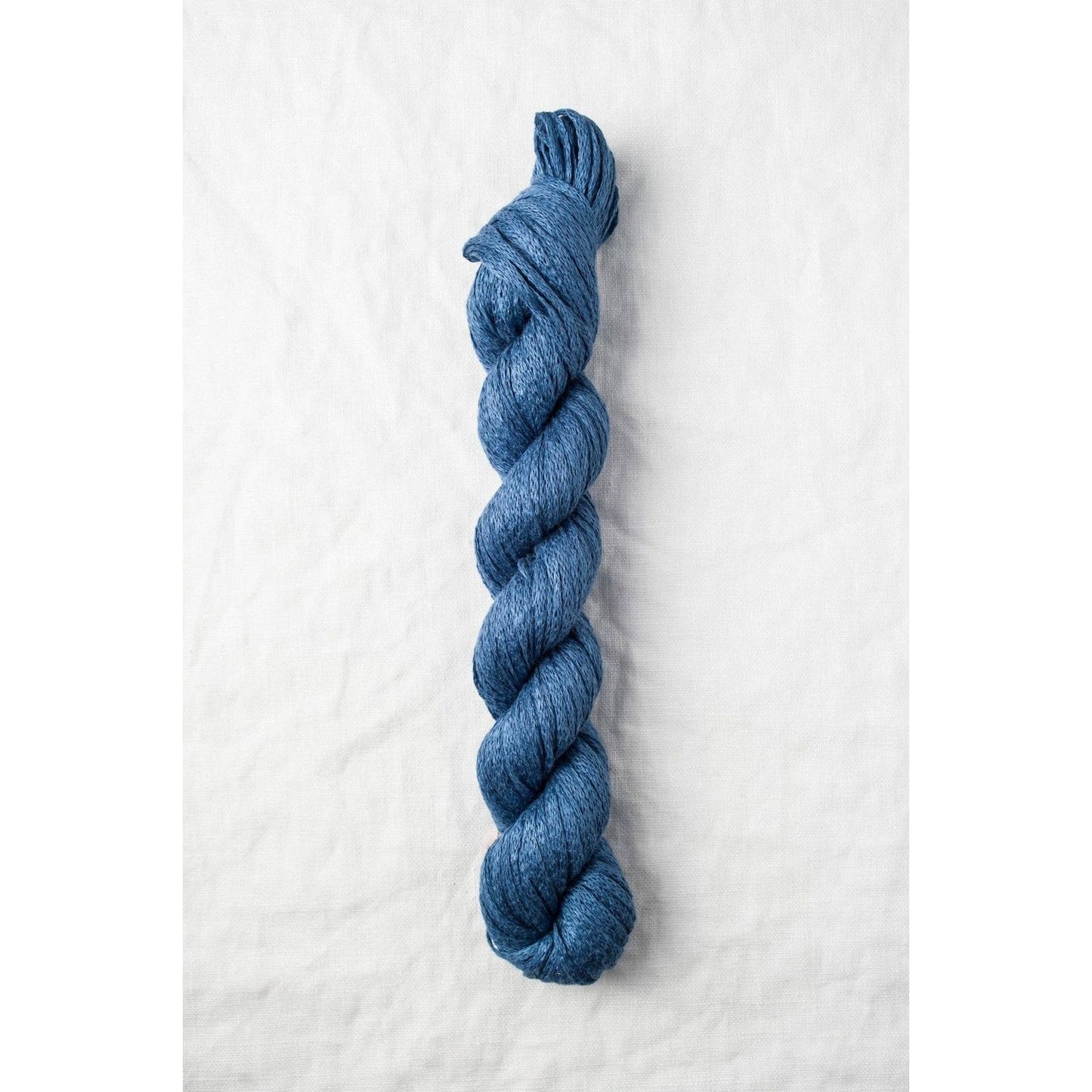 Quince & Co. organic Italian yarn in a rich blue color, ideal for knitting and crocheting projects