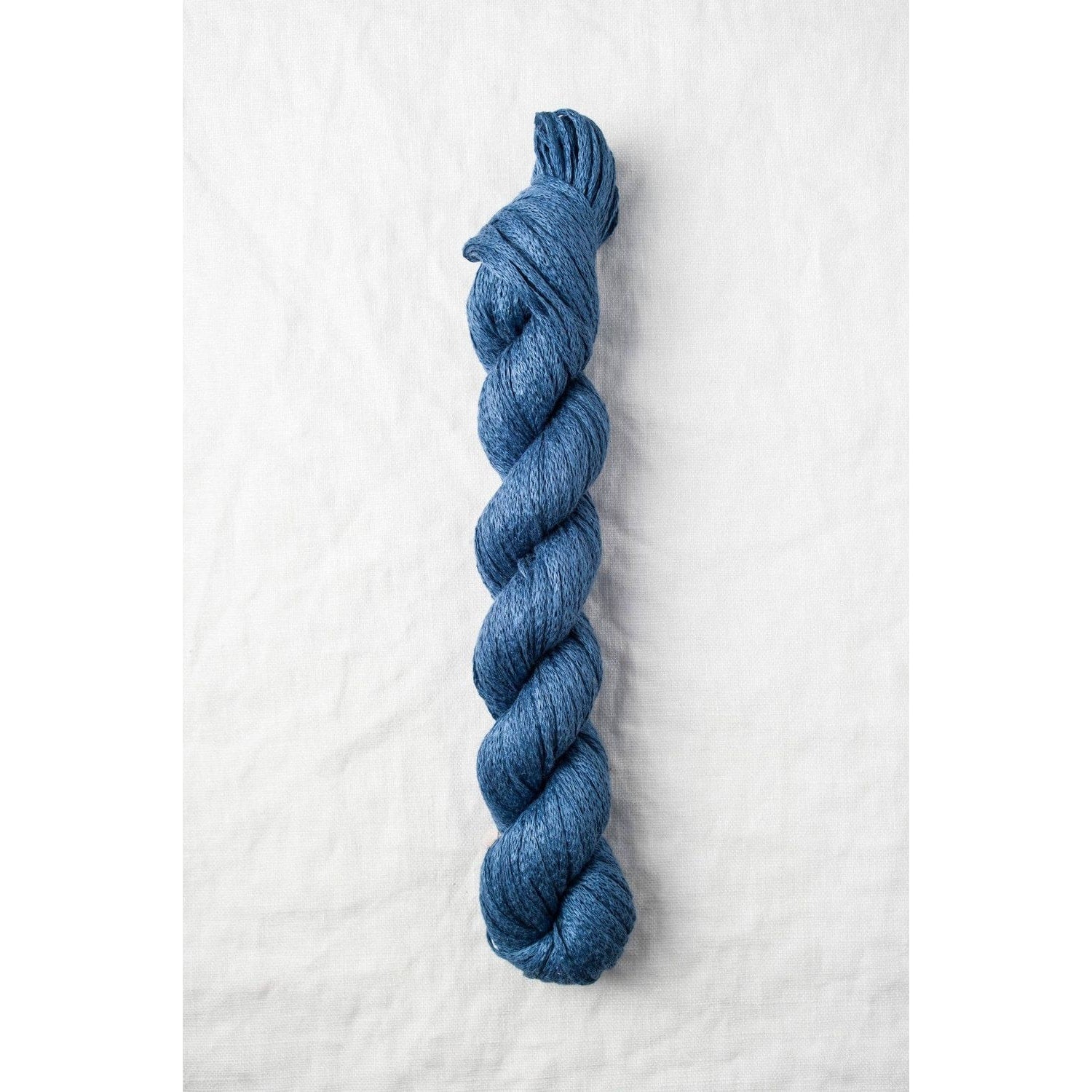 Quince & Co. organic Italian yarn in a rich blue color, ideal for knitting and crocheting projects