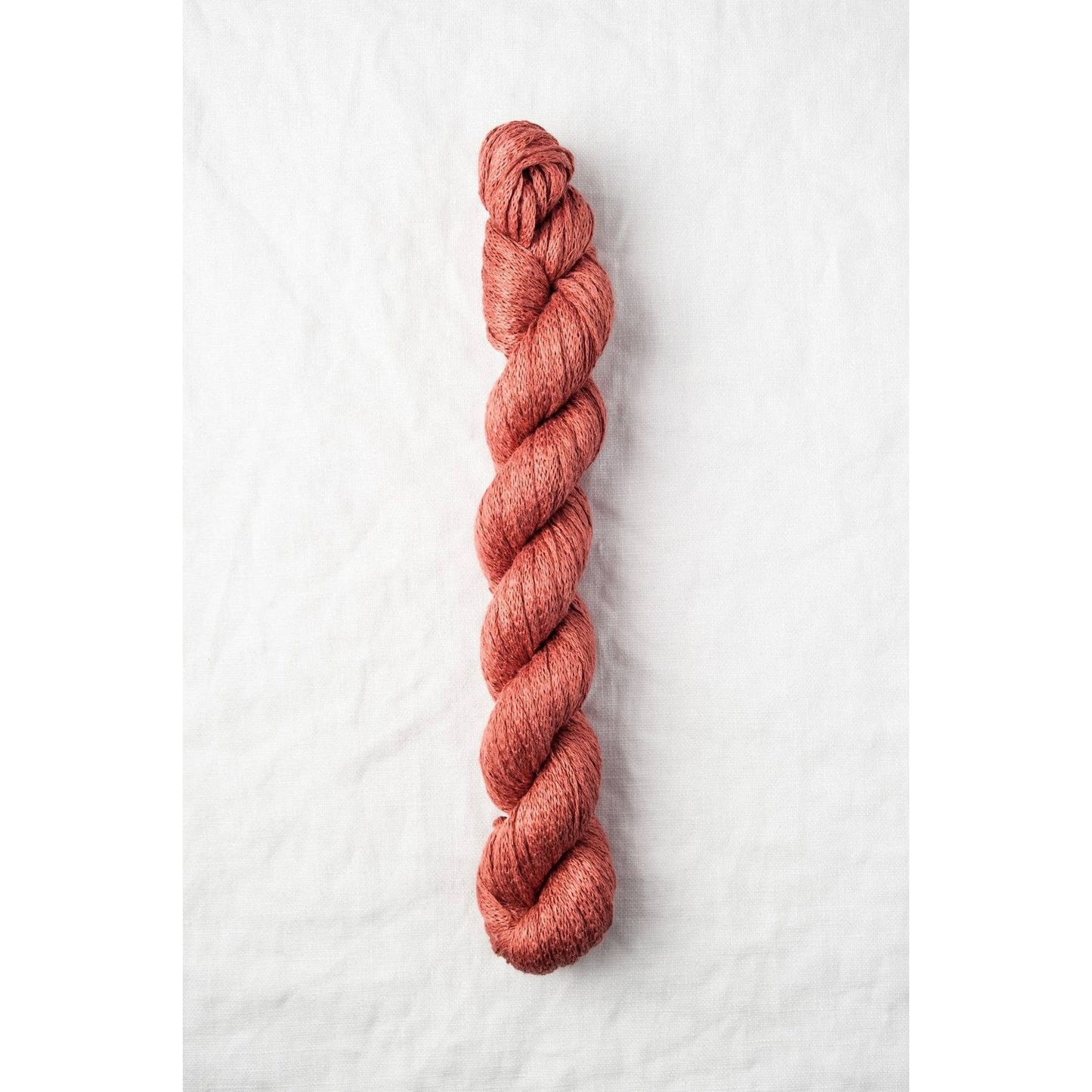 Quince & Co. organic Italian yarn in rich rust color, perfect for knitting and crocheting projects
