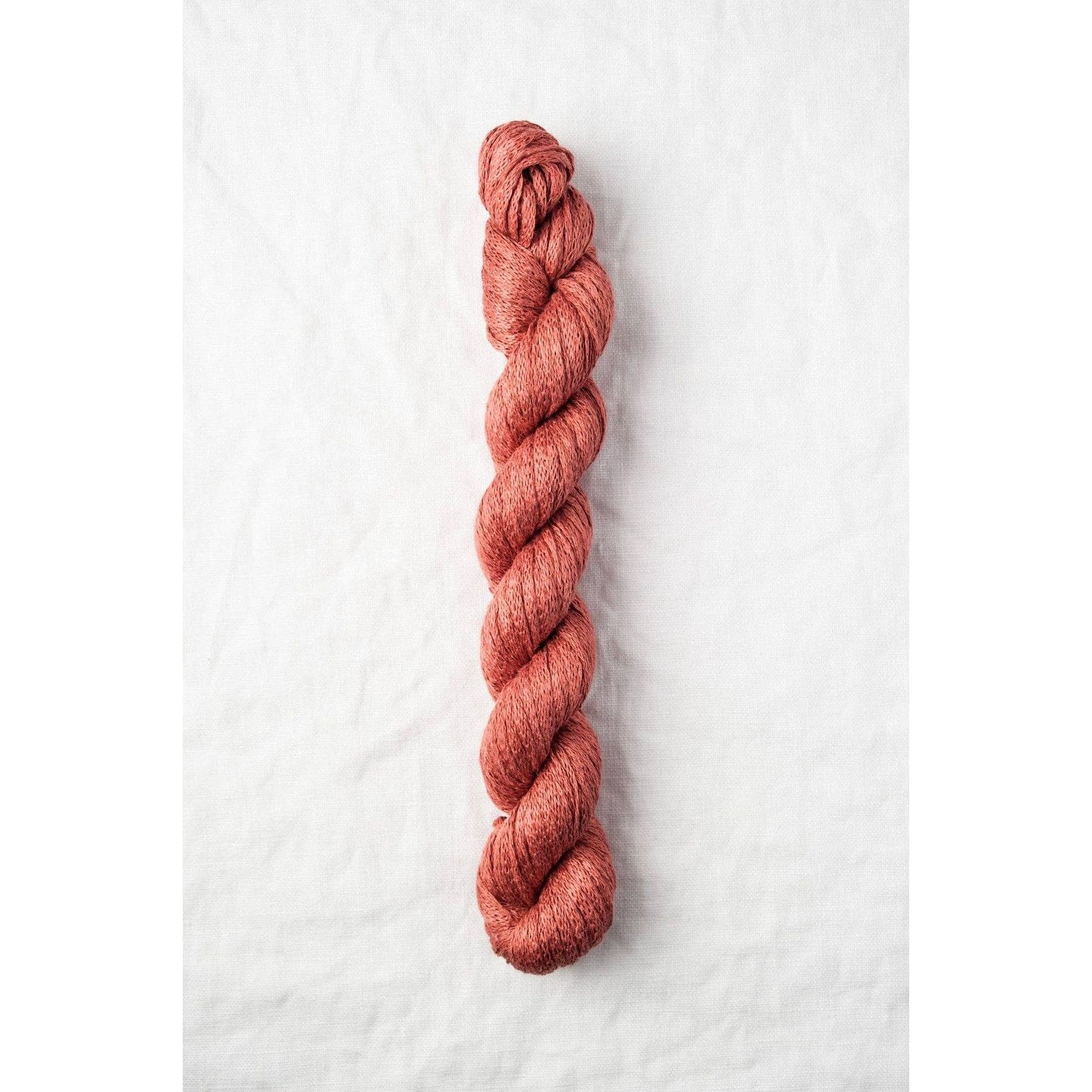 Quince & Co. organic Italian yarn in rich rust color, perfect for knitting and crocheting projects