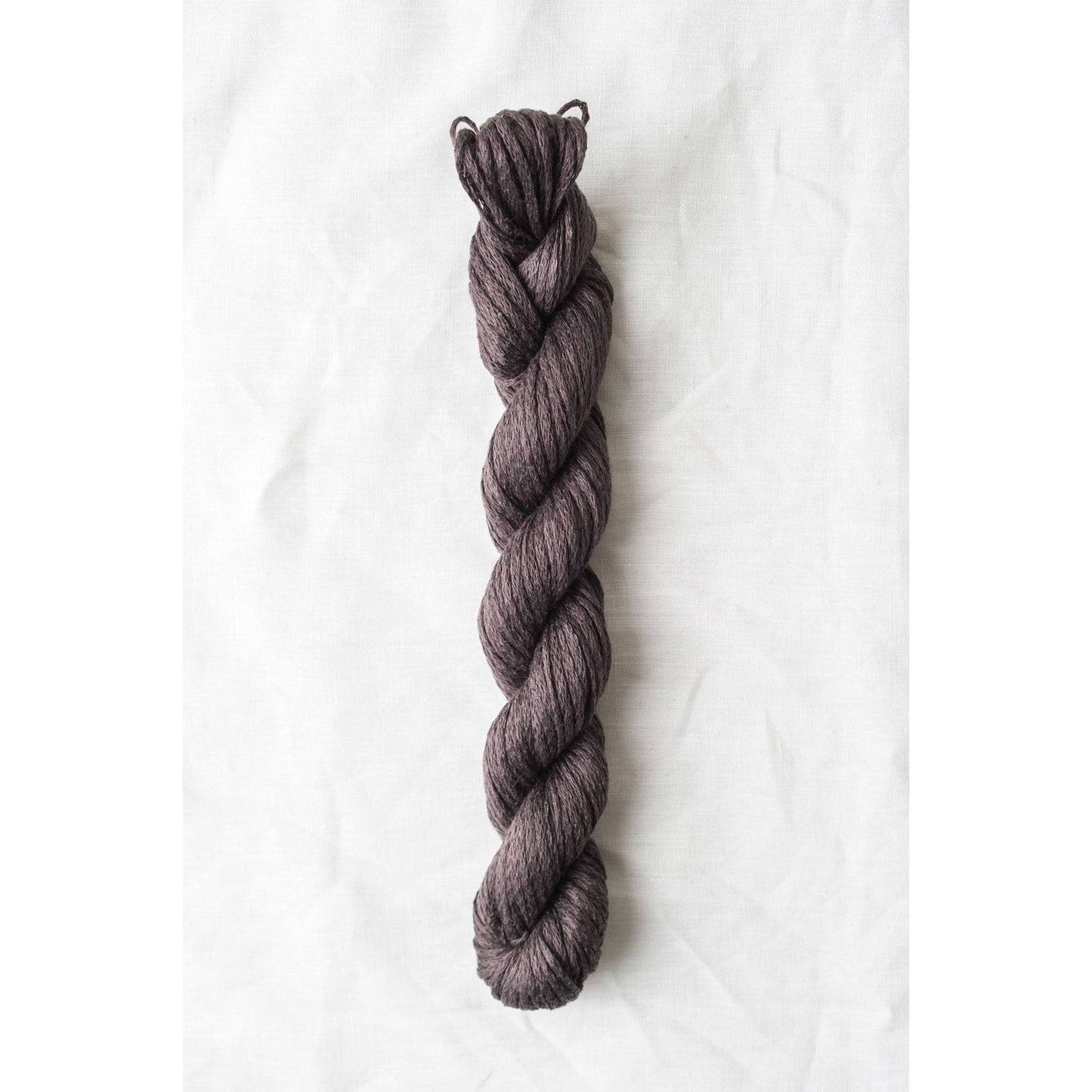 Quince & Co. organic Italian yarn in a rich, dark purple twist for knitting and crocheting projects