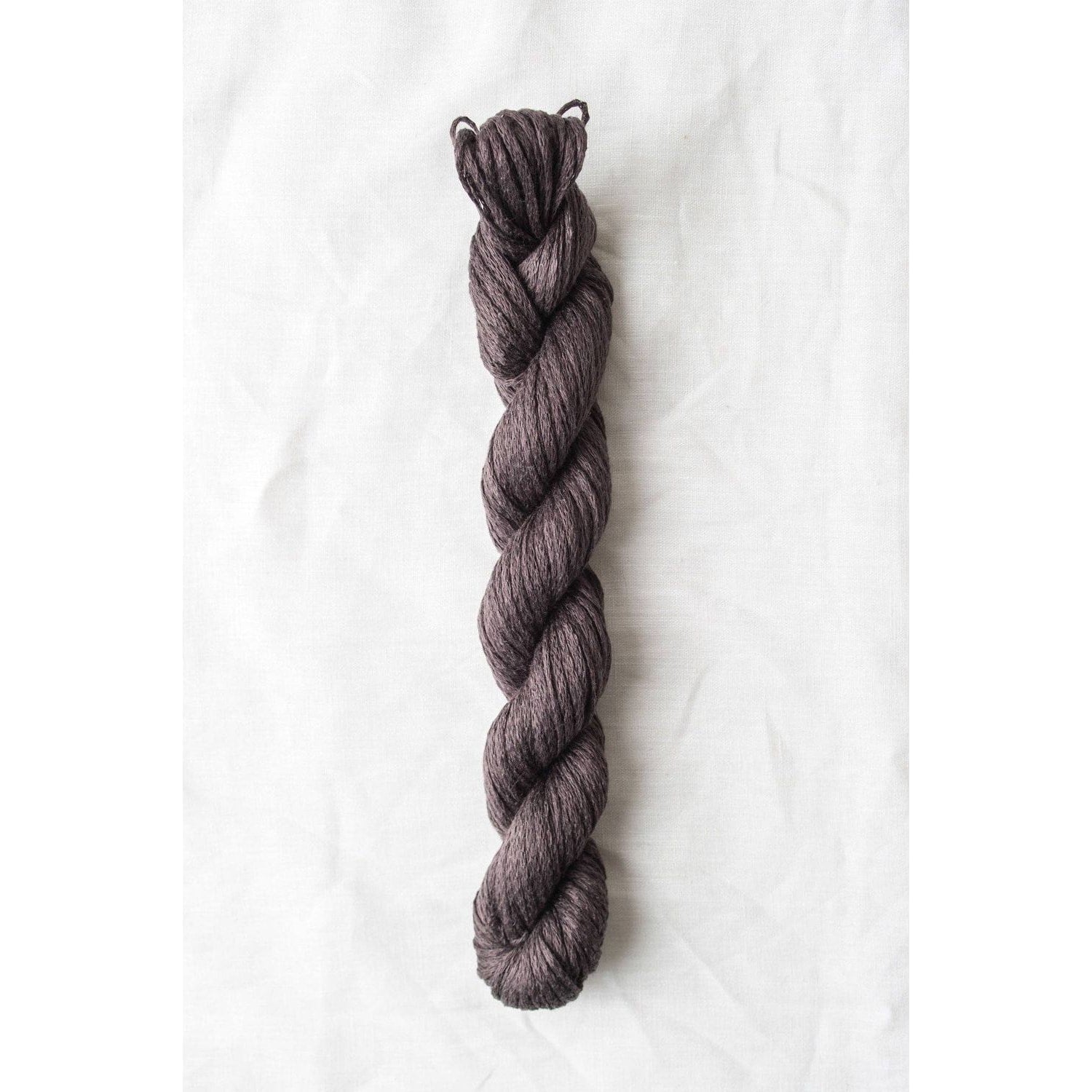 Quince & Co. organic Italian yarn in a rich, dark purple twist for knitting and crocheting projects