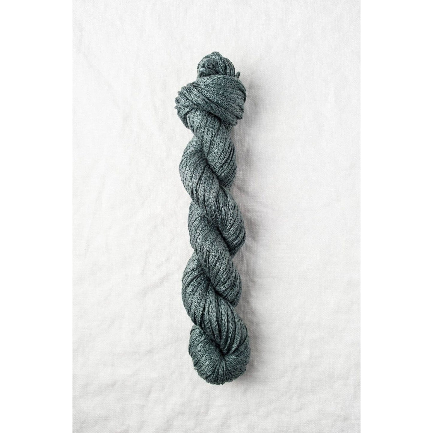 Quince & Co. Organic Italian yarn in a rich teal color, perfect for knitting and crochet projects