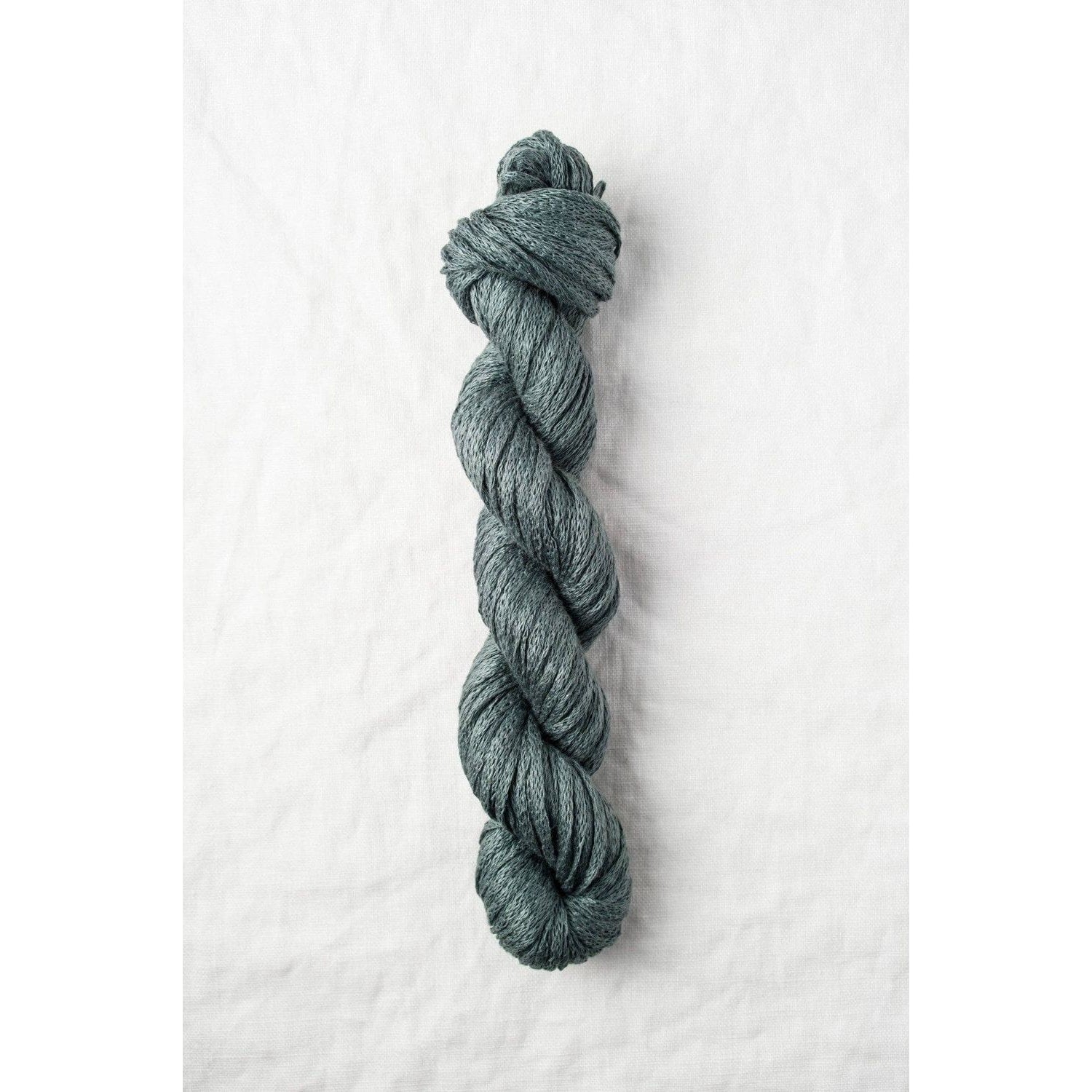 Quince & Co. Organic Italian yarn in a rich teal color, perfect for knitting and crochet projects
