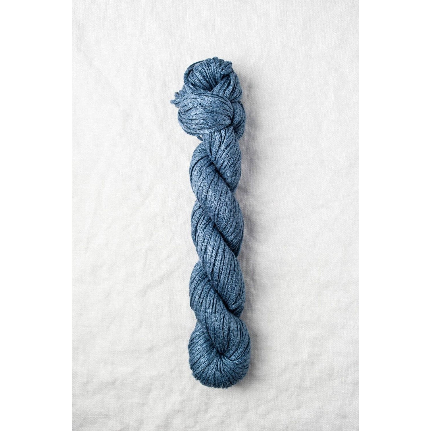 Quince & Co. organic Italian yarn in a rich blue color, ideal for crafting and knitting projects