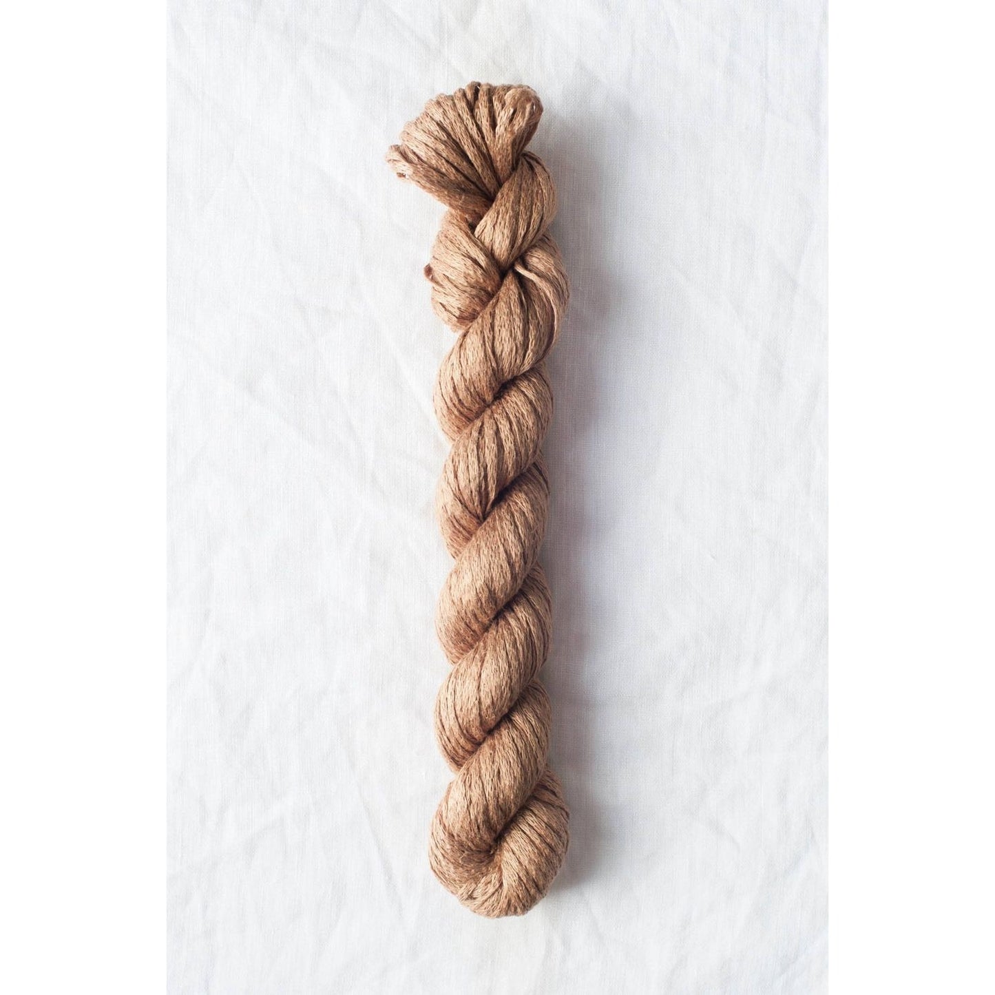 Quince & Co. Organic Italian yarn in a soft, natural brown shade for eco-friendly knitting projects