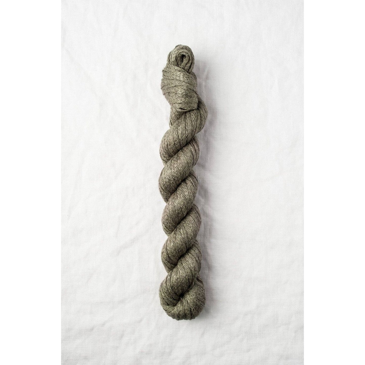 Quince & Co. organic Italian yarn in a soft olive green color, perfect for knitting and crafting projects
