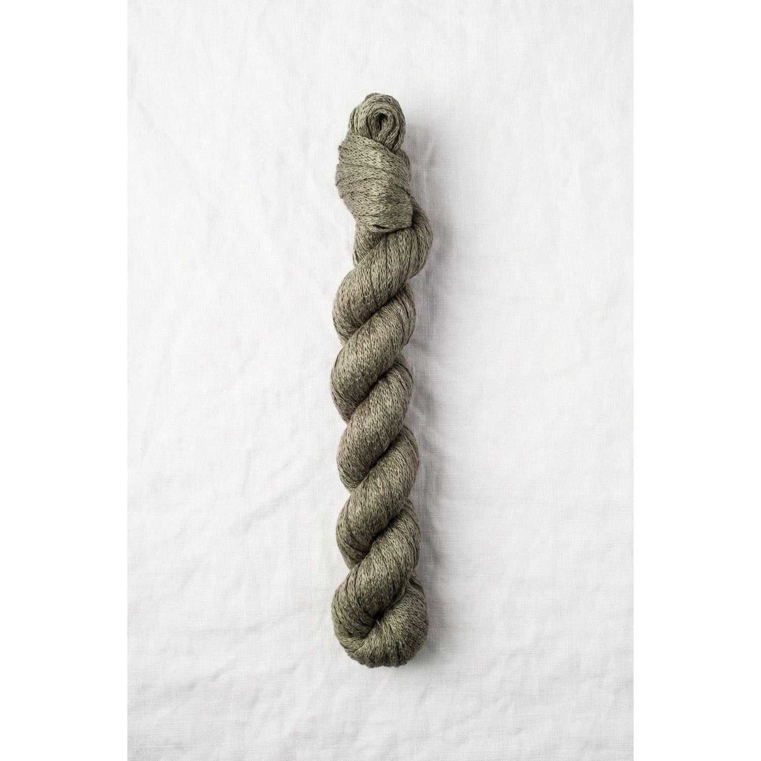 Quince & Co. organic Italian yarn in a soft olive green color, perfect for knitting and crafting projects